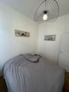 Ένα ή περισσότερα κρεβάτια σε δωμάτιο στο Entre Gare et Centre ville