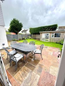 a patio with a table and chairs on a patio at Pet friendly, spacious house, sleeps 6 in Llanbadarn-fawr