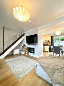 a large living room with a staircase and a living room at Pet friendly, spacious house, sleeps 6 in Llanbadarn-fawr