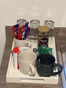 a tray with cups and other ingredients on a counter at X marina breeze x in Swansea +17 photos