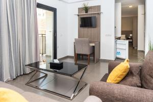 a living room with a couch and a table at Rise Urban Art Hotel in Larnaca