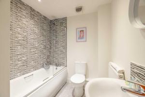 a white bathroom with a toilet and a sink at Modern Home - Slough, Heathrow, Pinewood - Parking in Langley Marish +13 photos
