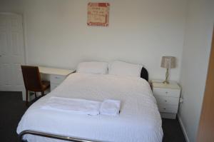a bedroom with a bed with two towels on it at ACCANE in Sunderland