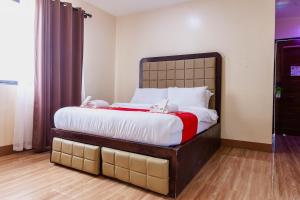 a bedroom with a large bed in a room at Balai La Niña Beach Resort in Aclan