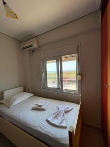 a bedroom with a bed with two towels on it at The Countryside in Sarandë