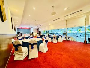 a banquet hall with tables and chairs in a room at Fortune Plaza Hotel, Dubai Airport in Dubai