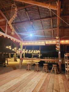 a large room with tables and cows in a building at Kubo ni Apple in Tagbina