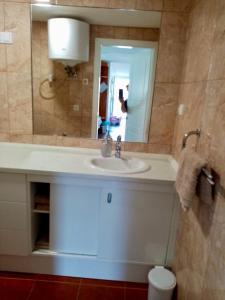 a bathroom with a sink and a mirror at Sára Vendégház Buzsák in Csisztapuszta +7 photos