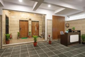 a lobby with potted plants and a large window at BluO Studios - Koramangala in Bengaluru +17 photos