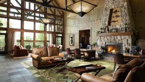 a living room with couches and a stone fireplace at Marriott Willow Ridge Luxury Studio in Branson