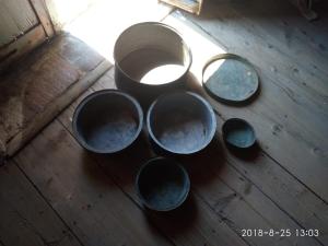 a group of bowls sitting on a wooden floor at Latmos 1860 in Skala