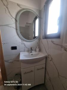 a bathroom with a sink and a mirror at Cabanele Borsa View in Borşa +38 photos