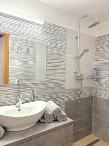 a bathroom with a sink and a shower at Tokaj Lamour in Tokaj +17 photos