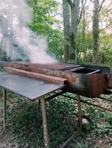 a bbq grill with smoke coming out of it at La Ferme de Plénoise Chambre & Table d'hôtes in Fricambault +45 photos