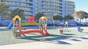a playground with a slide in a park at ALEXANDRA´s BEACH-PORT in Badalona