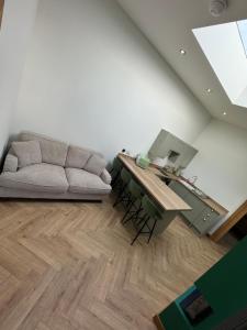 a living room with a couch and a table at Cosy Luxury apartment in Wick