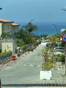 a street with cars parked in a parking lot at Villa Vera Tropea - free parking in Tropea