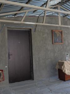 a door to a room with a table and a table sidx sidx at Առանձնատուն Սուրբ Հովհաննեսի և Թռչկանի տարածքում in Tsaghkaber