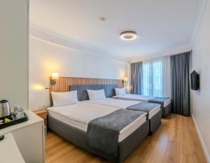 A bed or beds in a room at Silvana Hotel
