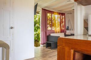 a kitchen and living room with a couch and a table at Montete Cottage Hilltop Villa with Beautiful Estate Garden in Choiseul