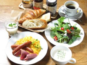 a table with plates of breakfast food and a cup of coffee at Kadoya Hotel in Tokyo