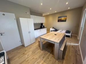 a kitchen with a wooden table in a room at Sala Monteur Apartment in Rodenbach