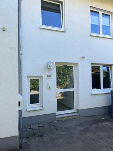 a white house with three windows on it at Stilvolle Maisonette mit Charme in Bad Honnef am Rhein
