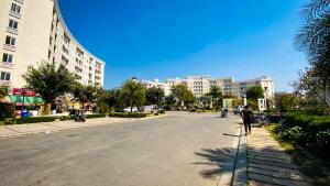 a person walking down a street in a city at VisitorStayInn in Vrindāvan