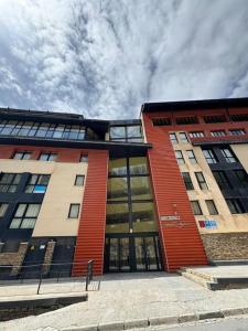 a large building with a red at Triplex Loft Mountain ZONA BAJA in Sierra Nevada