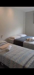 two beds sitting next to each other in a room at Villagio Coqueiro in Luis Correia