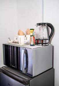a microwave with a coffee pot on top of it at Carolina Resort in Carolina