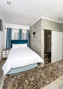 a bedroom with a large bed with a blue headboard at Carolina Resort in Carolina +28 photos