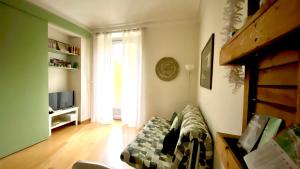 a living room with a couch and a television at Casa Dante in Turin