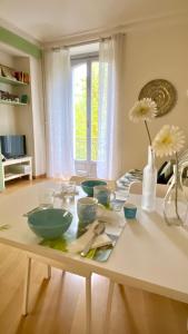 a table with bowls on it in a living room at Casa Dante in Turin