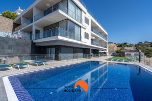 a hotel with a swimming pool in front of a building at #235 New City by Home Holidays in Páteo