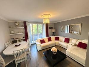 a living room with a couch and a table at Appartement confort avec balcon - Champigny in Champigny-sur-Marne