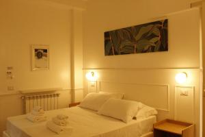 Ένα ή περισσότερα κρεβάτια σε δωμάτιο στο Don Raffaele Resort Roma - Guest House