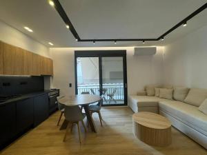 a living room with a table and a couch at BlueMotion - PortSuite 4A in Piraeus