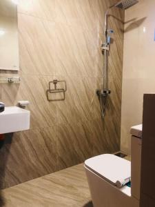 a bathroom with a shower and a toilet and a sink at R21 Nuwara Eliya in Nuwara Eliya +49 photos