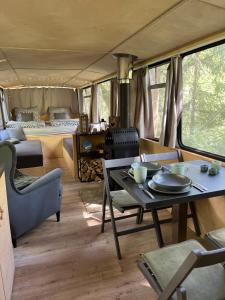 a living room with a table and a couch at Magicbus in Podtureň