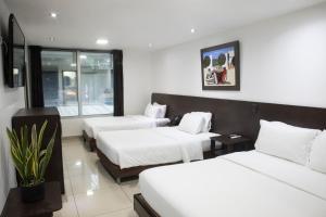 Ένα ή περισσότερα κρεβάτια σε δωμάτιο στο Hotel Acqua Medellín