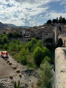 a view of a city with a bridge and a river at Besalú Pont Vell Apartment in Besalú