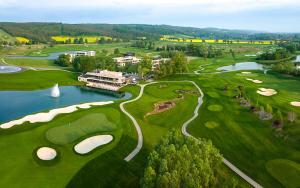 an overhead view of a golf course with a pond and golf courses at Ulics vendégház II in Zalacsány