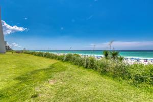 a path to the beach with the ocean in the background at Beach House Condominiums B101 - Beachfront with Pool, WiFi, & Beach Service in Destin