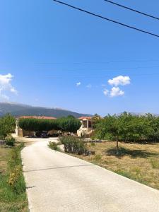 a road leading to a house with trees on the side at Eirini- Ioanna in Sami