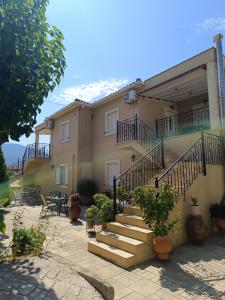 a house with stairs and tables and chairs at Eirini- Ioanna in Sami