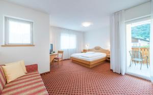 Ένα ή περισσότερα κρεβάτια σε δωμάτιο στο Saldur Small Active Hotel