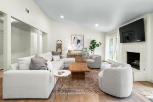 a living room with a white couch and two chairs at Austin Oasis Zilker, Downtown, Pool, 3 Bedroom in Austin
