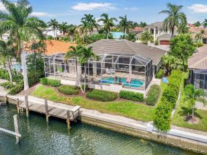 an aerial view of a house on the water at W exposure waterfront home with pool and dock in Marco Island