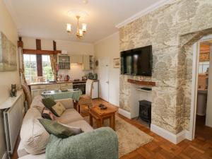 a living room with a stone wall at Fox Cottage in Droitwich +11 photos